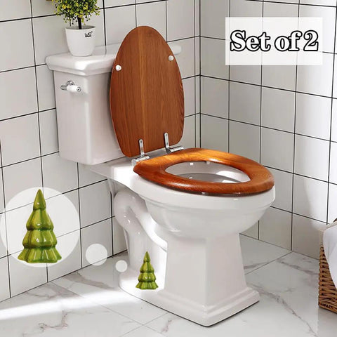 Set Of Two Green Christmas Tree Toilet Bolt Covers That Snaps Right On In Seconds And Brings Hella Cute Holiday Bathroom Decor To Any Home While Keeping Ugly Bolts Straight Outta Sight All Season Long on a white toilet with wooden seat.