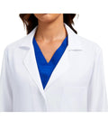 Close-up of Three Pocket Women's Lab Coat With Long Sleeves White Medical Coat Relaxed Fit Size M over blue scrubs.