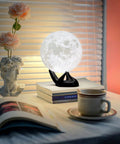 Moon Lamp 7.1 Inch 3D Printed Lunar Night Light With 16 Colors on black stand, glowing in cozy room setting