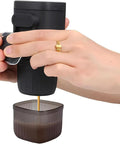 Person using the Smooth Operator Hand Pump Espresso Maker For Pods Or Grounds Portable Travel Coffee Brewer to brew coffee.
