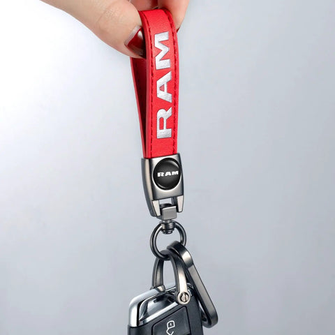 Slick Genuine Leather Car Key Chain Ring Compatible With Dodge Ram 1500 2500 3500 Featuring A Hella Sturdy Zinc Alloy Charm And Top Shelf Finish For Your Daily Driver In Vibrant Red, close-up showing red leather strap and key fob.