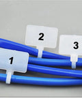 Rock Solid 100 Pack Nylon Self Locking Cable Ties With Write On Labels securing blue cables with label tags for organization