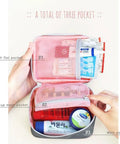 Open Pink Mini Outdoor First Aid Kit Bag for Travel and Everyday Use, showing handy pockets with medical supplies inside.
