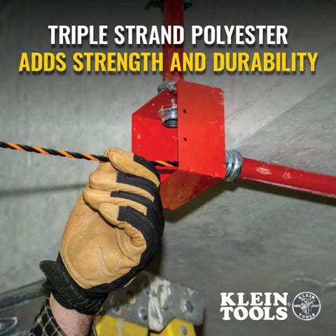 Hand gripping High Flex 75 Foot Tri Strand Polyester Fish Tape for smooth electrical wire pulling in tight spaces.
