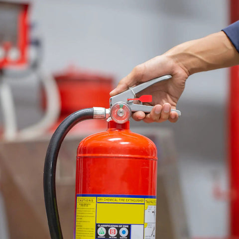 Top Grade 2000 Pack Fire Extinguisher Tamper Seals Plastic Safety Lock Pins Red Security Zip Ties For Office Industrial Equipment Management Heat Resistant Universal Fit with hand on red fire extinguisher nozzle.