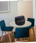 Tour Ready Waterproof Drum Backpack And Oxford Cloth Gig Bag With Padded Adjustable Straps on a table in a modern setting.