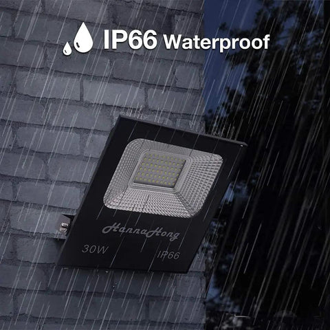 Beefy 30W LED Flood Light With 5 Ft Cable And Switch mounted on wet brick wall, IP66 waterproof, highlighting outdoor durability.