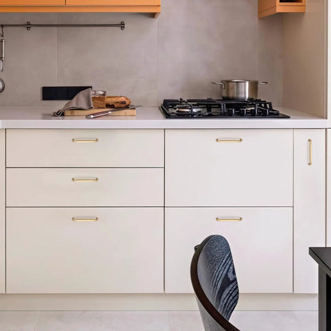 Front view of a modern kitchen with Ten Pack 5 Inch Champagne Bronze Cabinet Handles In Solid Zinc Alloy on white cabinets.