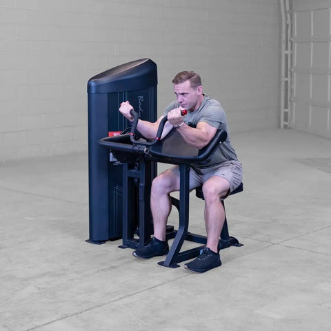 Man using Pro Clubline Bicep Preacher Curl Machine With Multi Grip Revolving Handle Bar And 235 Pound Weight Stack in home gym