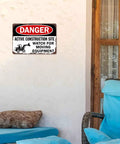 Active Construction Site Warning Sign Aluminum 8x12 Inch Rustproof Metal Wall Decor on white wall near patio chair.