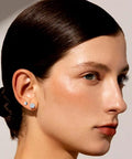 Snag These Fresh Flat Back Earrings Made From Light As Air Titanium Surgical Steel With Diamond Like Cubic Zirconia In Classic Round And Square Styles White Gold Plated Hypoallergenic Multiple Piercing Stud Set Truly Built For All Day Vibes worn in model's ear, showing two styles, 3mm and 5mm.