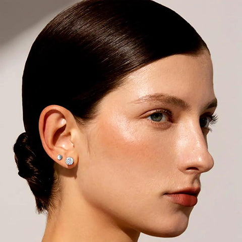 Snag These Fresh Flat Back Earrings Made From Light As Air Titanium Surgical Steel With Diamond Like Cubic Zirconia In Classic Round And Square Styles White Gold Plated Hypoallergenic Multiple Piercing Stud Set Truly Built For All Day Vibes worn in model's ear, showing two styles, 3mm and 5mm.