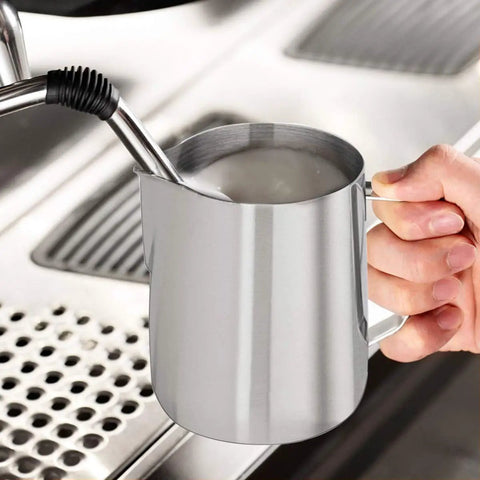 Person holding Milk Frothing Pitcher 12oz And 20oz Stainless Steel Jug For Espresso Machines And Latte Art, steaming milk