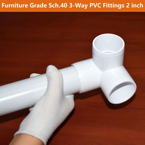 Hand holding 2 Inch PVC Fittings 3 Way Elbow Connectors Four Pack Furniture Grade Heavy Duty For DIY Furniture Frames UV Resistant.