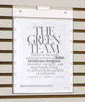 Three Pack 8.5x11 Clear Slat Wall Sign Holders For Menus And Flyers displaying flyer on slat wall