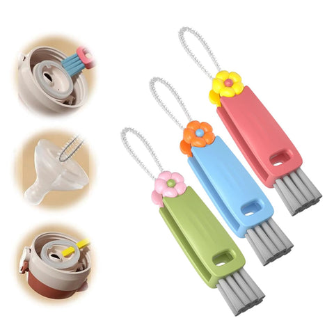 3-piece cup lid gap cleaning brush set with flower-topped handles in pink, blue, and green; angled side view.