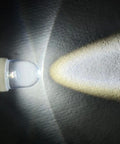 Image of a lit 6V E10 Mini LED bulb showcasing its crisp white light beam, featuring E10 wedge base for easy installation.