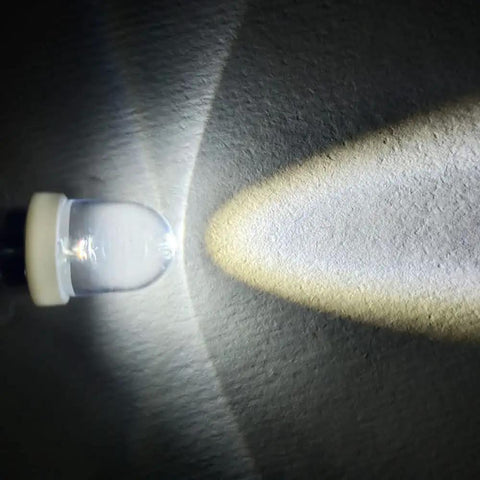 Image of a lit 6V E10 Mini LED bulb showcasing its crisp white light beam, featuring E10 wedge base for easy installation.
