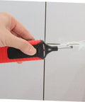 Hand using Tile Repair Kit For Porcelain And Marble Color Wax Blocks For Quick Scratch Chip Repair on a tile surface.