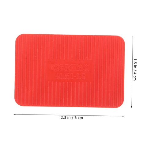 Red plastic door frame shim from 100 pcs set, dimensions 2.3x1.5 inches, part of load bearing leveling wedges for windows and doors.