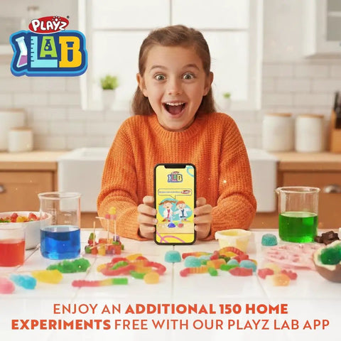 Child excitedly holding phone in kitchen with colorful candy from Hands On Edible Candy Making Science Kit For Kids Ages 8 To 12 With 40 Fun Experiments To Craft Chocolates Jelly Candies Rock Candy Lollipops And More Educational Sweet Science.