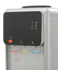Close-up of Triple Temperature Water Dispenser with hot, cold, and room temperature faucets; freestanding electric cooler and heater.