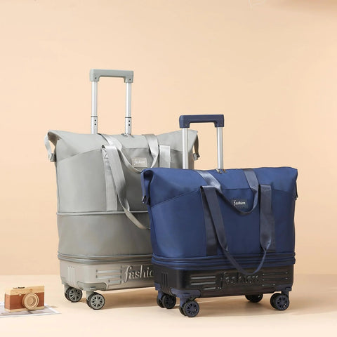 Front view of two rolling duffle bags with wheels and telescoping handles; blue and gray carry-on luggage.