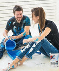 Couple working on DIY home project with Heavy Duty Concrete Crack Filler And Cement Repair Sealant in smooth grey packaging.
