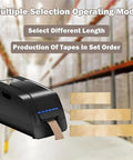 Heavy Duty Paper Based Top Shelf Electric Automatic Tape Dispenser Burns Through Water Activated Tape Flat Out, showing multiple tape lengths.
