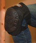 All Day Comfort Hinged Gel Knee Pads with slip resistant rubber caps on a construction site, showing quick release clips and straps
