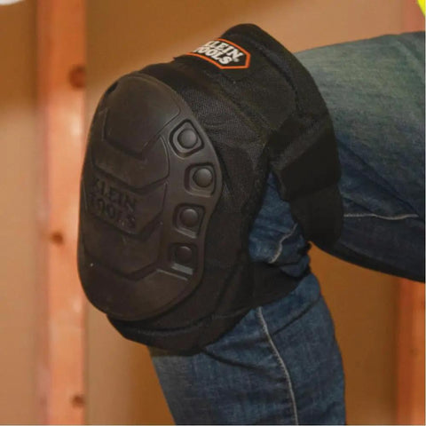 All Day Comfort Hinged Gel Knee Pads with slip resistant rubber caps on a construction site, showing quick release clips and straps