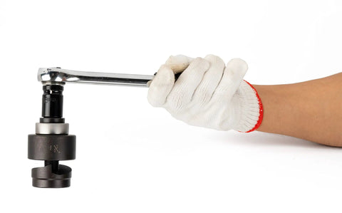 Gloved hand using Ratchet Knockout Punch Set With 6 Dies From Half Inch To Two Inch For Electrical Conduit Heavy Duty Hole Cutter.