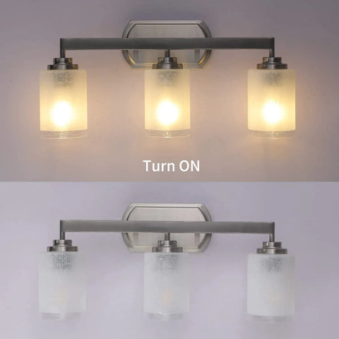 Three Light Brushed Nickel Vanity Light With Frosted Glass Shades, Wall Mount Sconce For Bathroom And Over Mirror, Modern Indoor Lighting for hallway, living room, or entryway, dope finish, lit and unlit view.