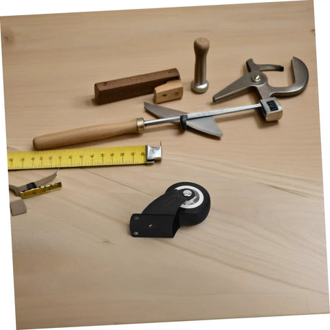 Built Tough Heavy Duty Sliding Door Wheels Featuring Whisper Quiet Rollers For Barn Door Hardware on a workbench with tools.