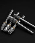 Front view of five tungsten carbide burrs with 1/4 inch shanks and knurled barrels; double-cut for metal and wood.