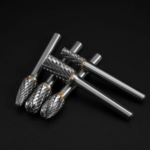 Front view of five tungsten carbide burrs with 1/4 inch shanks and knurled barrels; double-cut for metal and wood.