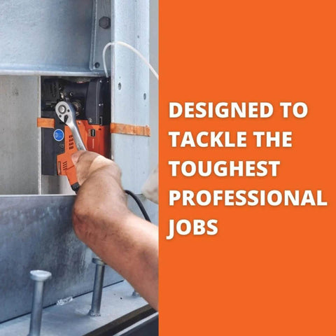 Side view of Fein JMC Magforce 90 magnetic base drill, orange/black, being operated by hand on metal.