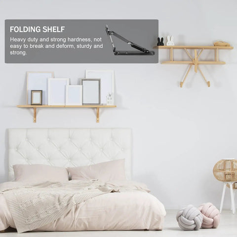 Heavy Duty Folding Wall Shelf Brackets Two Pack Black Iron Ultra Sturdy Support shown above a bed in a bedroom setting.