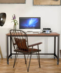 Smooth Ride Rolling Computer Desk With Lockable Wheels And Heavy Duty Steel Frame Portable Laptop Workstation Wide Wood Top in home office.