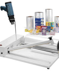 Pro Grade Manual Heat Seal And Cut Machine For Shrink Wrap with industrial body, cutter, and heat gun for efficient packaging.