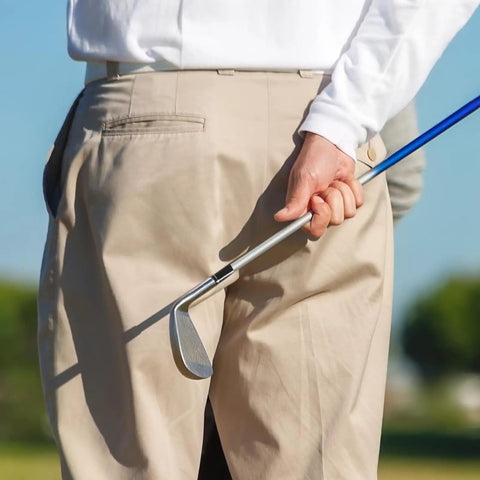 Golfer holding club with Black Golf Ferrule Set For Irons 12 Pack 0.335 Inch Tip Shaft Sleeve Adapter visible on the course