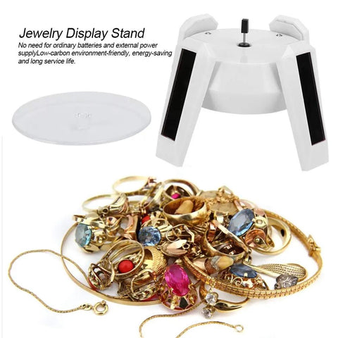 Solar Powered Jewelry Display Stand With 360 Degree Rotating Turntable And Blue LED Lights Electric Base For Showcase Counter Merchandise Presentation Cool Gift Idea with assorted rings and necklaces.
