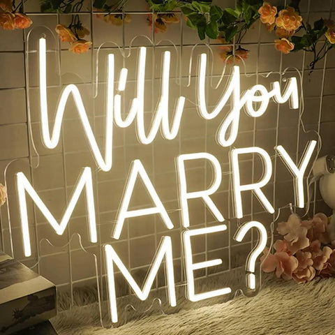 Will You Marry Me Neon Sign LED Proposal Light With Acrylic Backboard Large Marry Me Decor placed on wire backdrop with pink flowers