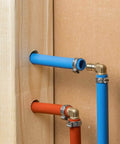 10 Pack Brass PEX Elbow Fittings One Half Inch 90 Degree For PEX Tubing Durable Potable Water Approved SDWA 2014 Compliant Plumbing Connectors Set Perfect For Home Renovation And New Installations In Indoor Or Outdoor Plumbing Projects, installed in blue and red PEX tubing in wall setup.