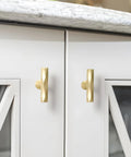Brushed Gold Cabinet Knobs 10 Pack Hammered Brass Handles for cabinets, drawers, and cupboards installed on white kitchen doors