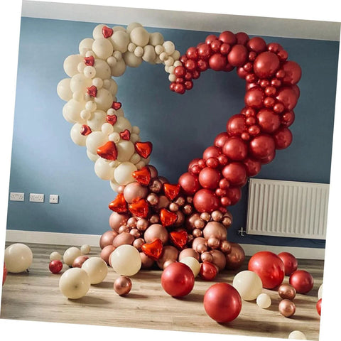 Front view of LABRIMP heart-shaped balloon arch made from cream and red pastel balloons for wedding decor.