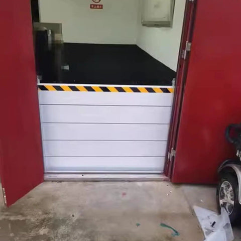 Heavy Duty Aluminum Flood Shields For Doors And Warehouse Openings, installed at a door with yellow caution stripes.