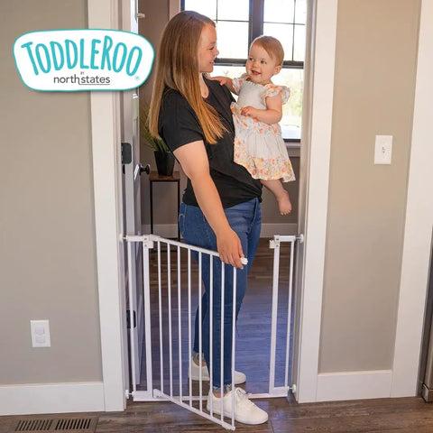 Ninja Level Heavy Duty Auto Close Baby Gate Featuring Hella Low Half Inch Threshold Easily Adjusts To Fit Any Standard Doorway Opening From 29 To 38 Inches Wide For Total Kid And Pet Safety with mother and toddler.