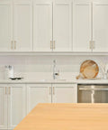 Modern white kitchen with 10 Pack 6 Inch Champagne Bronze Cabinet Handles Stainless Steel Modern Dresser Drawer Pulls on cabinets.