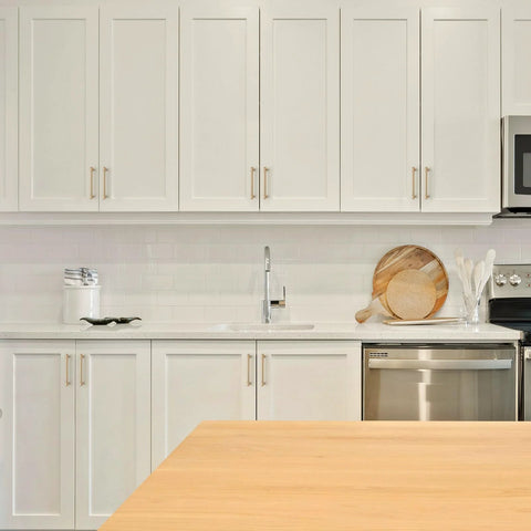 Modern white kitchen with 10 Pack 6 Inch Champagne Bronze Cabinet Handles Stainless Steel Modern Dresser Drawer Pulls on cabinets.